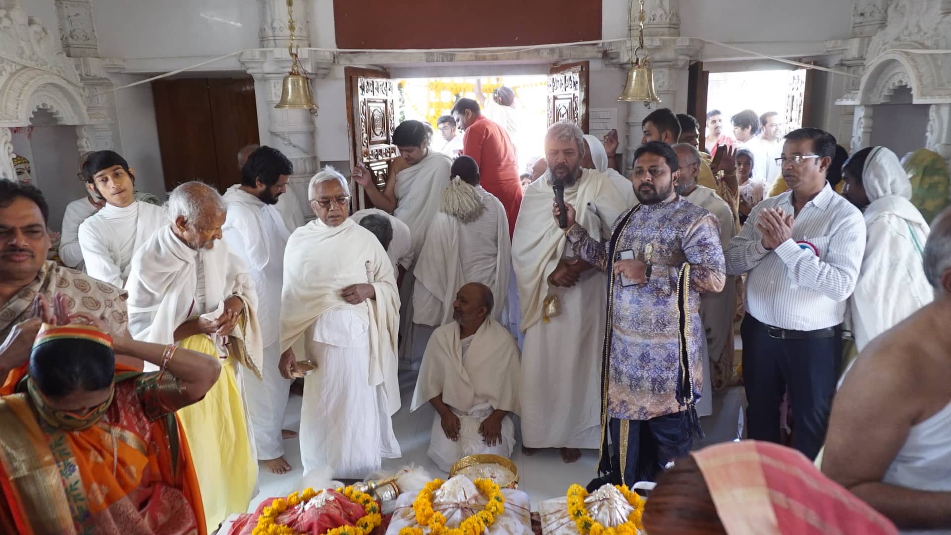 Devotees gathered inside the derasar during the pratishtha ceremony