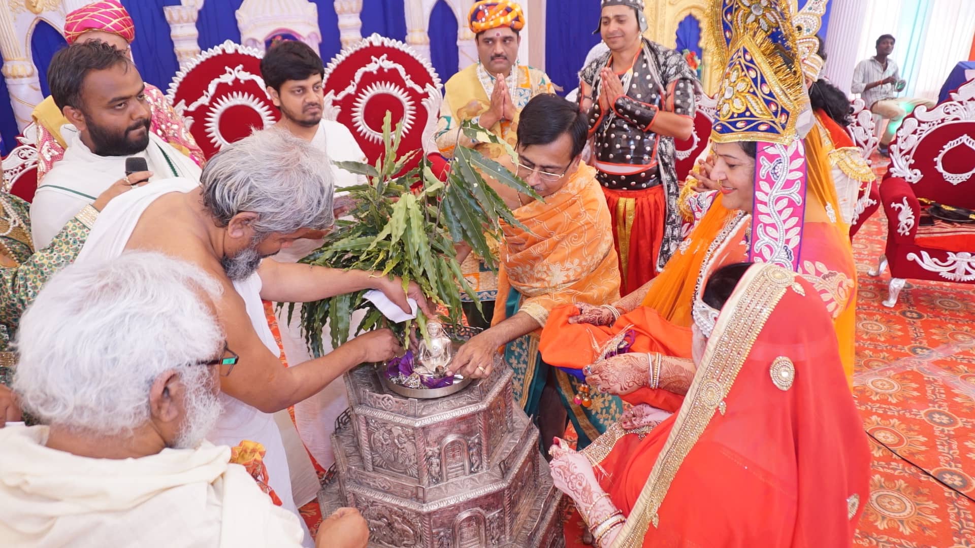 Devotees performing abhishek puja under a decorated pandal