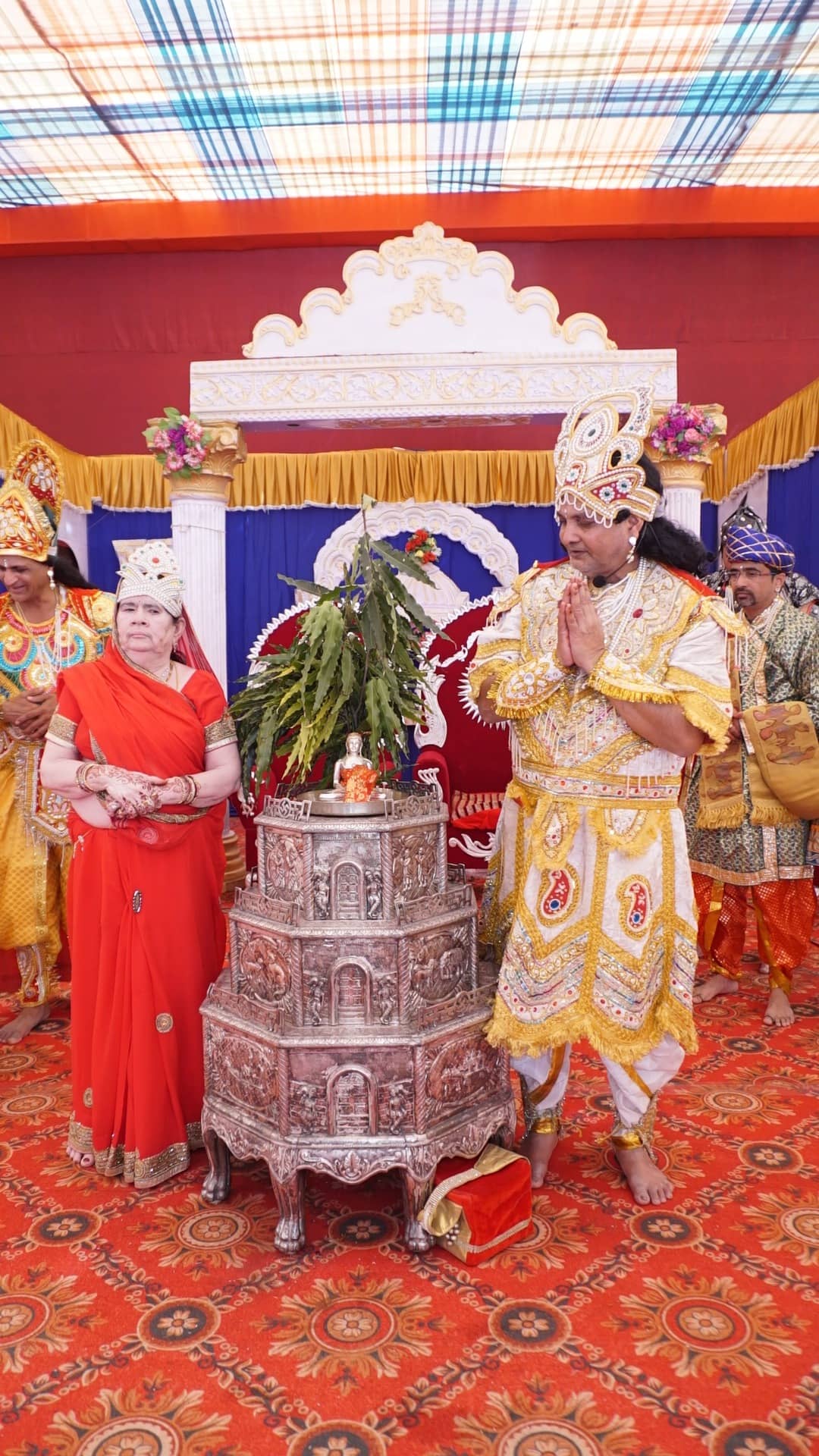 Devotees dressed as Indra and Indrani beside the silver samavasaran