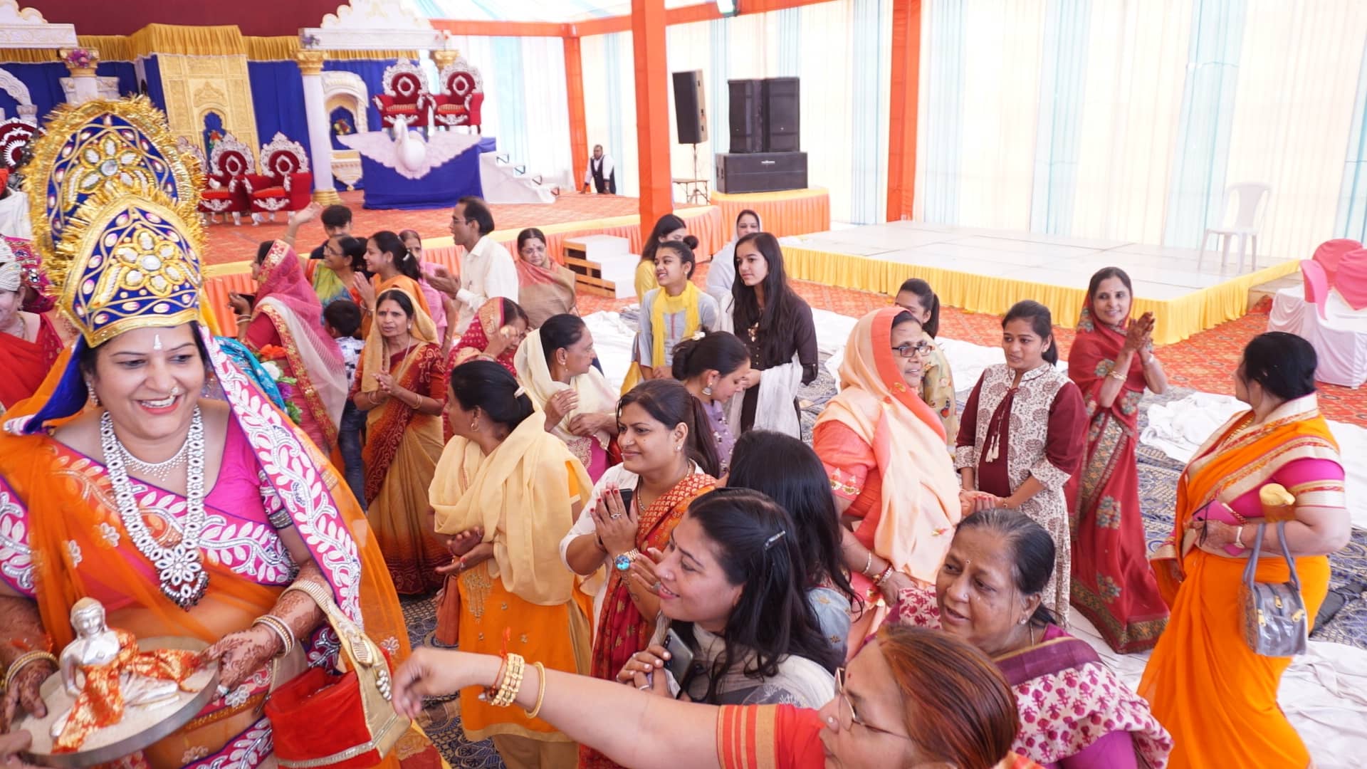 Women in festive saris offering puja during the celebrations