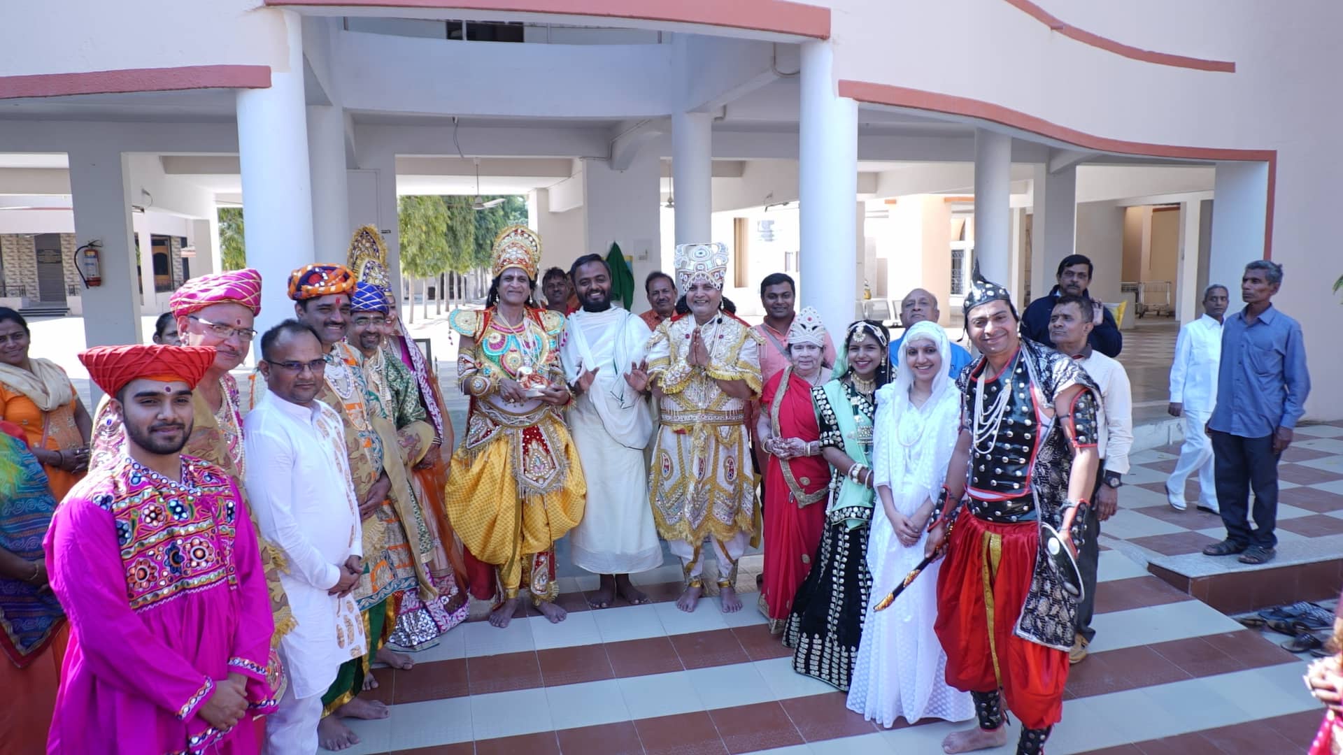 Guests in festive costume gathered on the steps of Jainsite Bhavan during the pratishtha celebrations