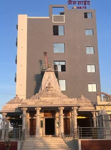 Marble Adinath Bhagwan derasar in front of the Jainsite building at sunset